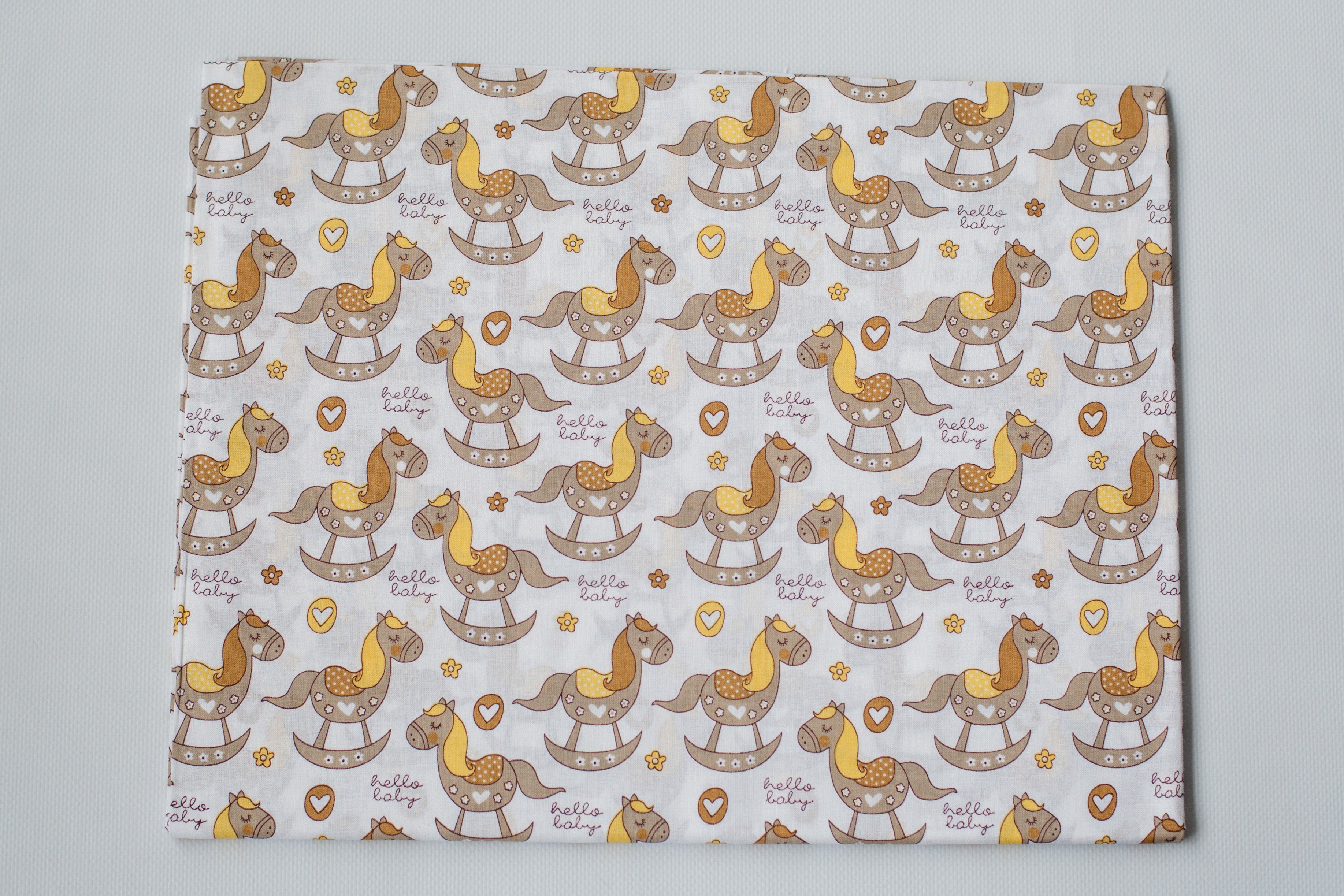 Regular Cotton Fabric - Zhelto Korychnevye Rocking Horses On White