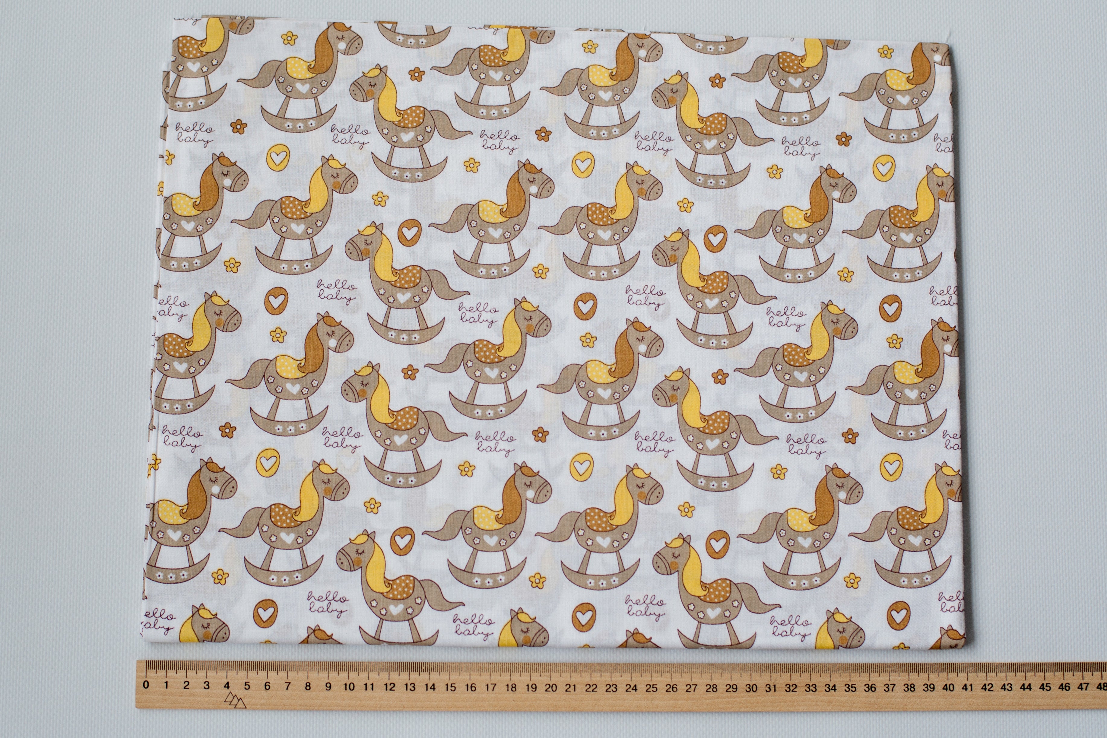 Regular Cotton Fabric - Zhelto Korychnevye Rocking Horses On White