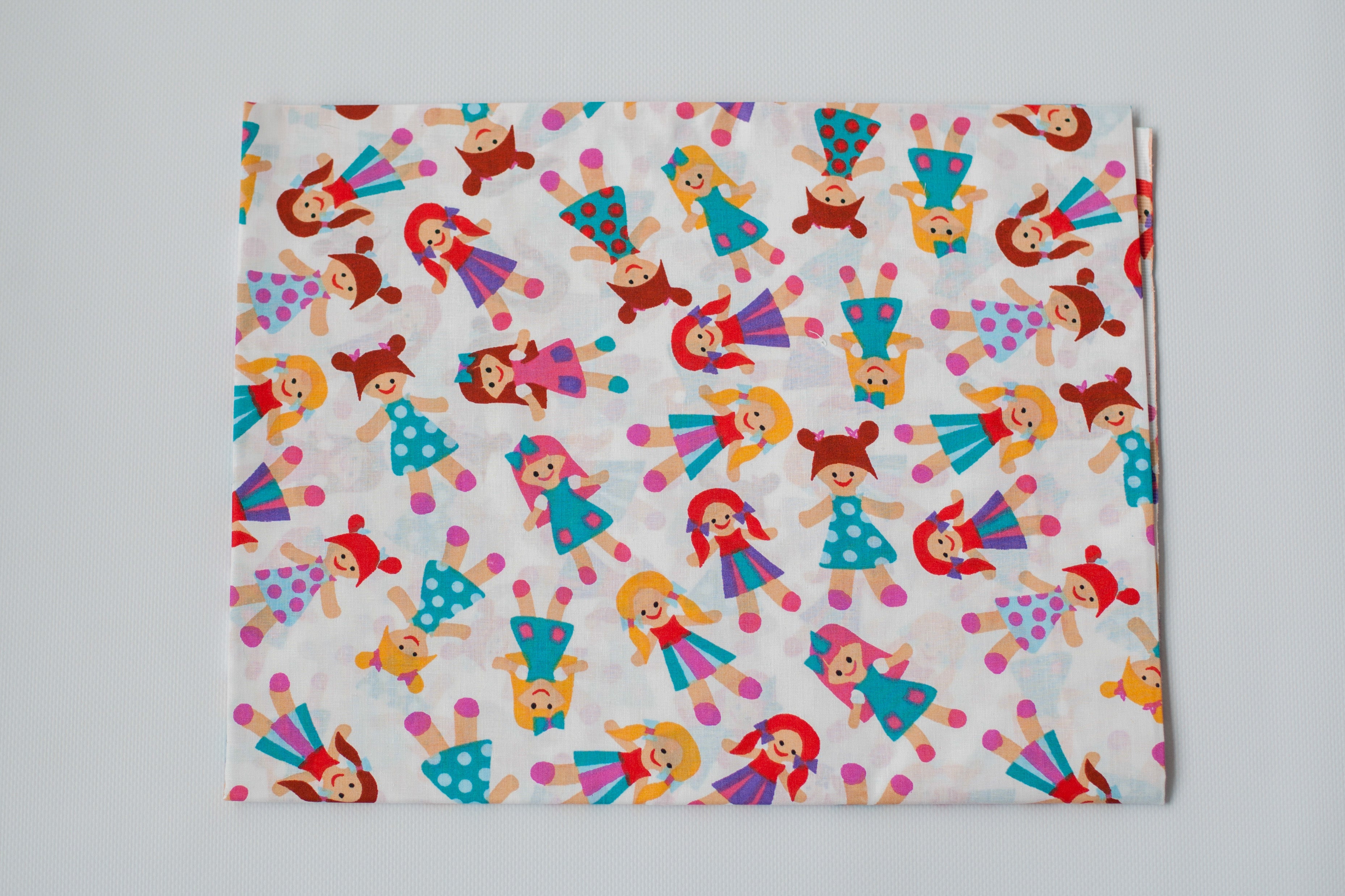 Regular Cotton Fabric - Multicolor Dolls On White
