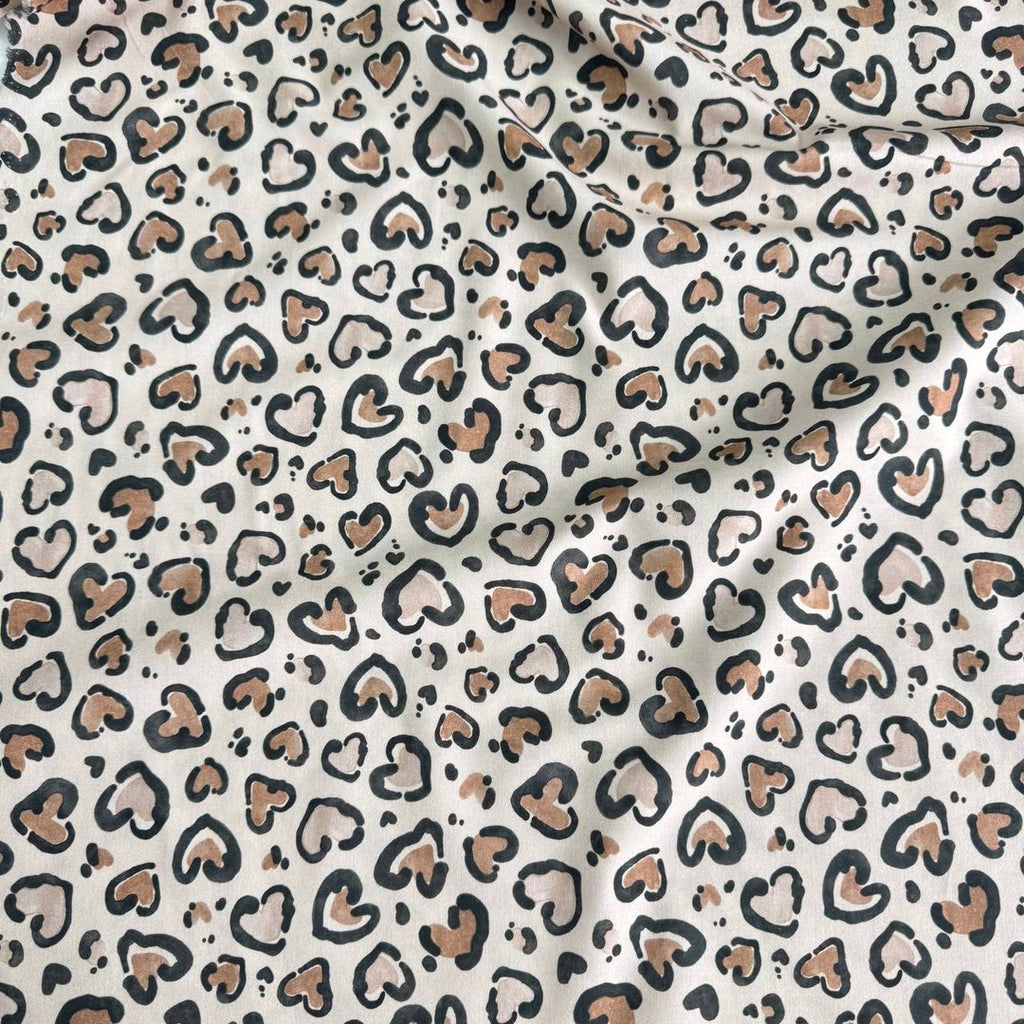 Leopard hearts on a beige background