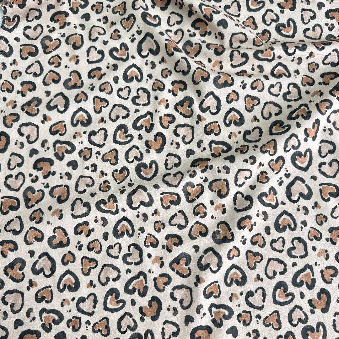 Leopard hearts on a beige background
