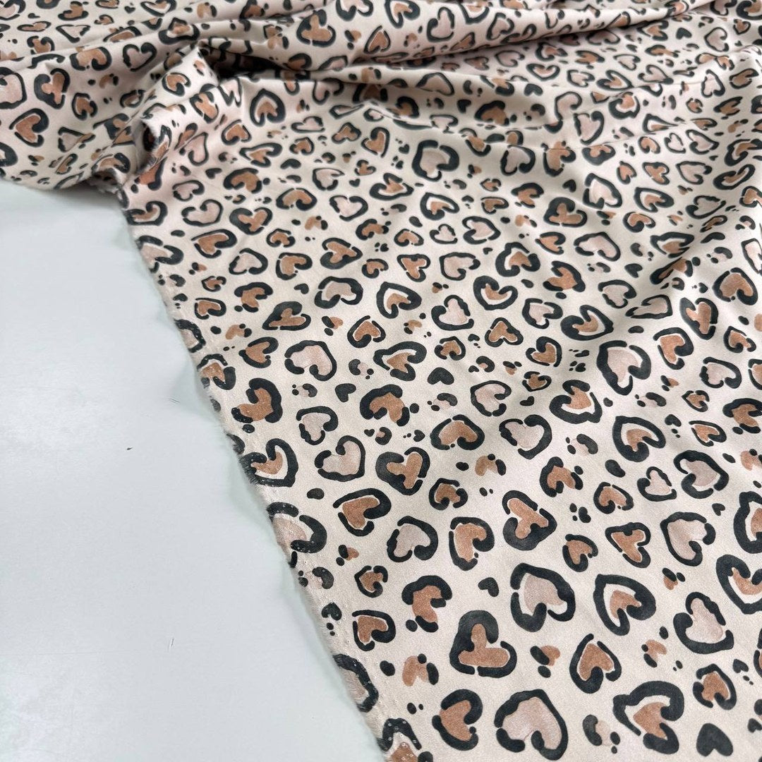 Leopard hearts on a beige background