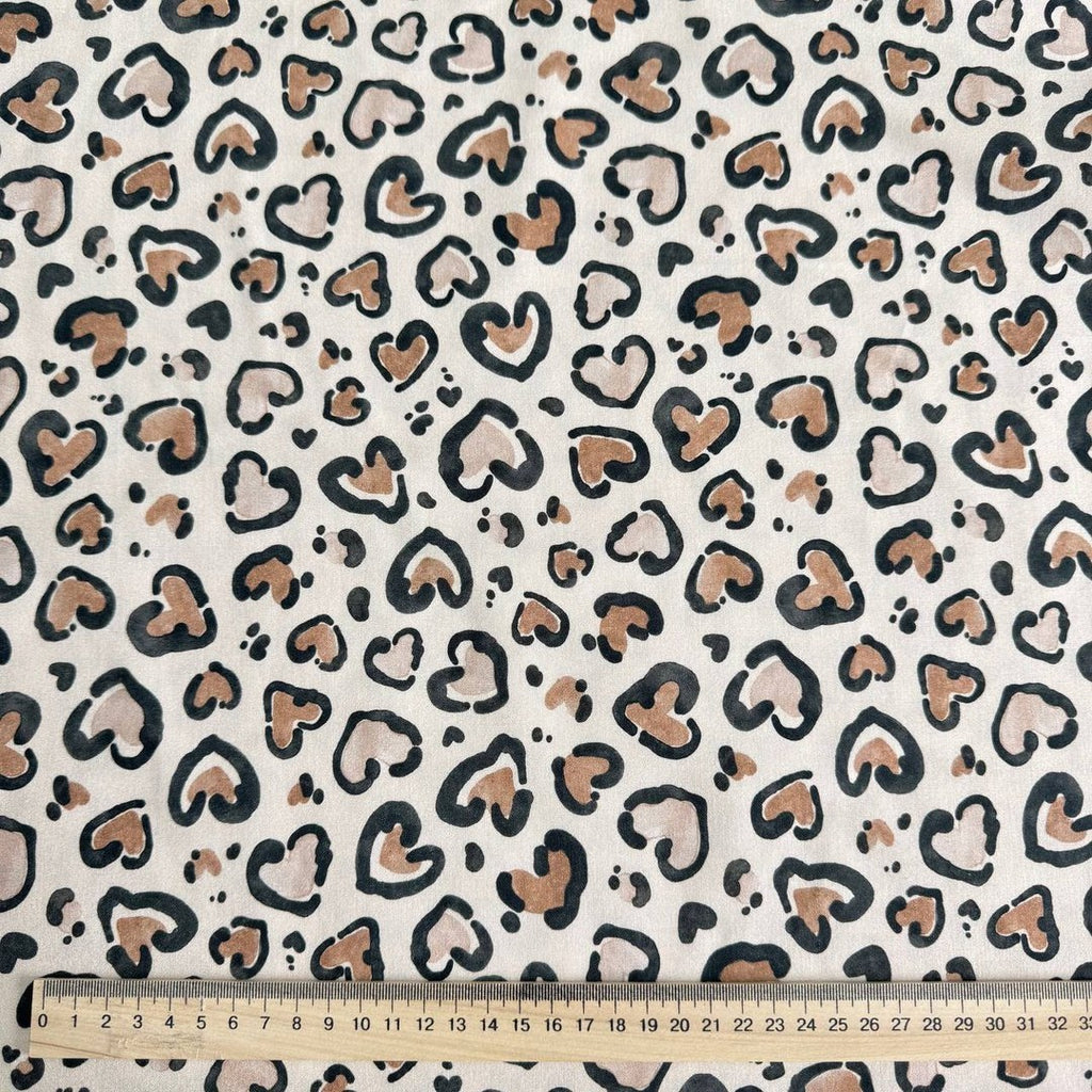 Leopard hearts on a beige background