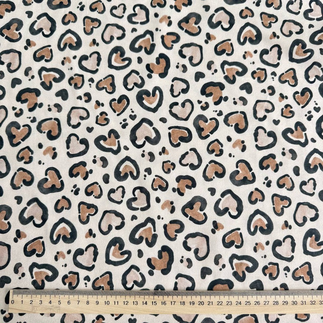 Leopard hearts on a beige background