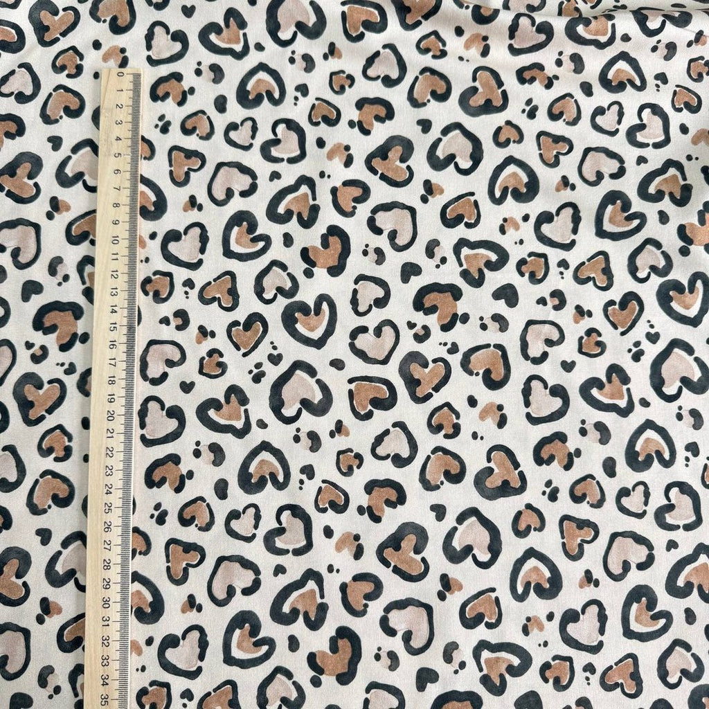 Leopard hearts on a beige background