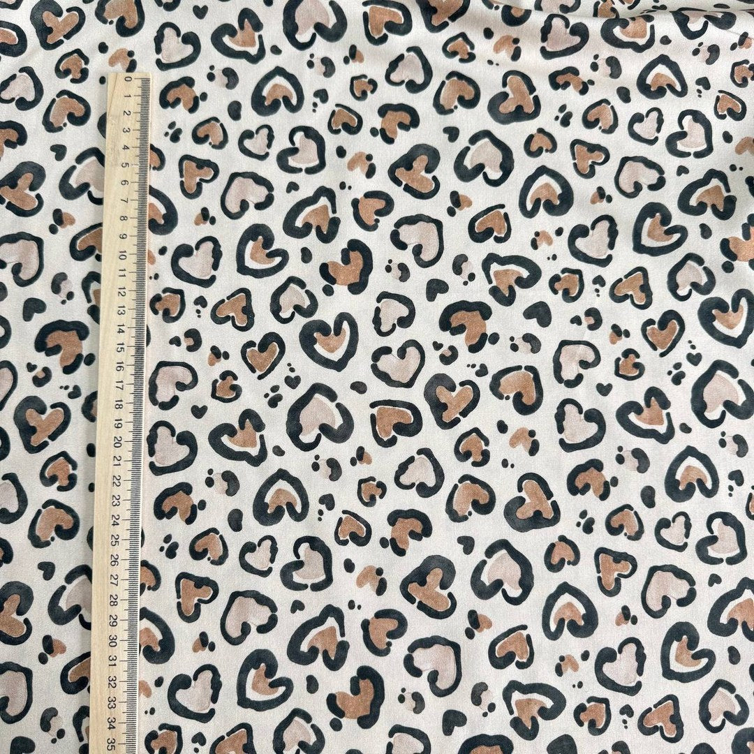 Leopard hearts on a beige background
