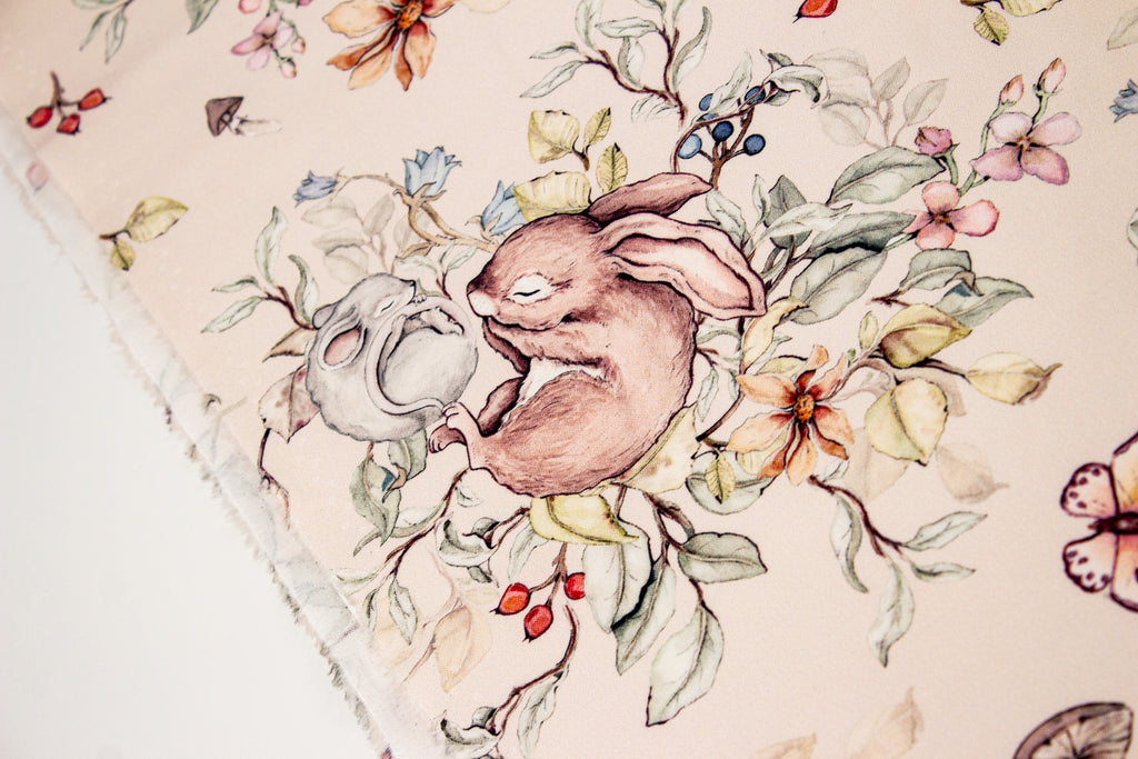 Bunny and mouse sleeping on a beige background
