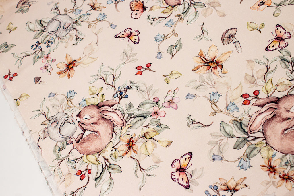 Bunny and mouse sleeping on a beige background