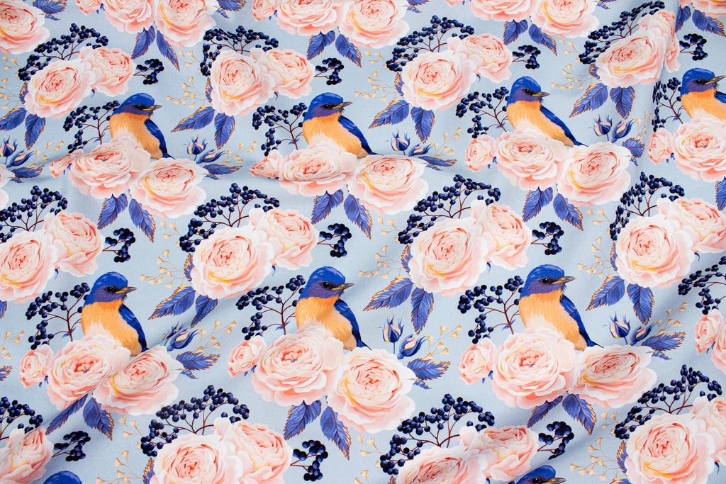 Roses with a bird on blue