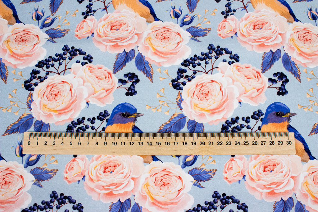 Roses with a bird on blue
