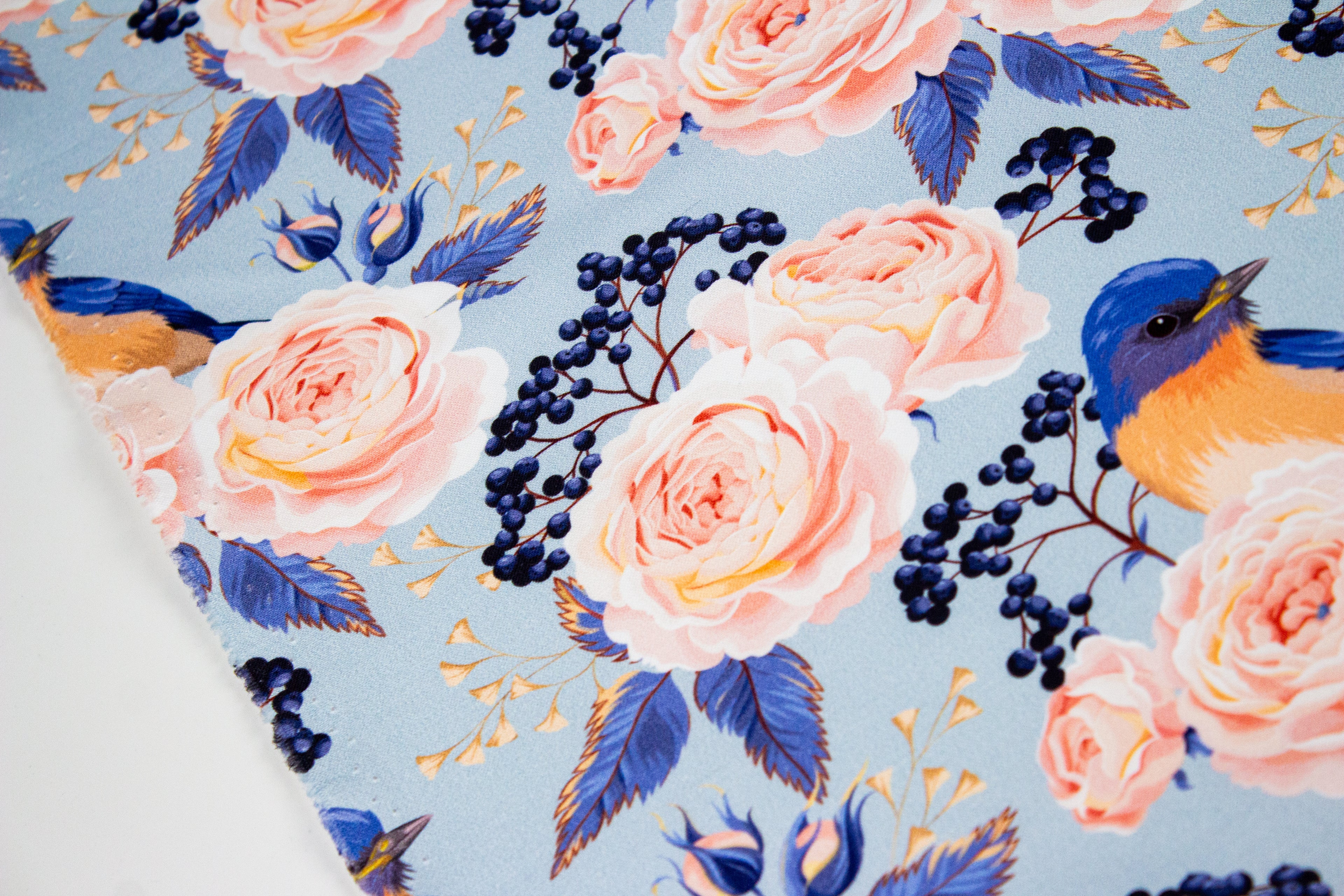 Roses with a bird on blue