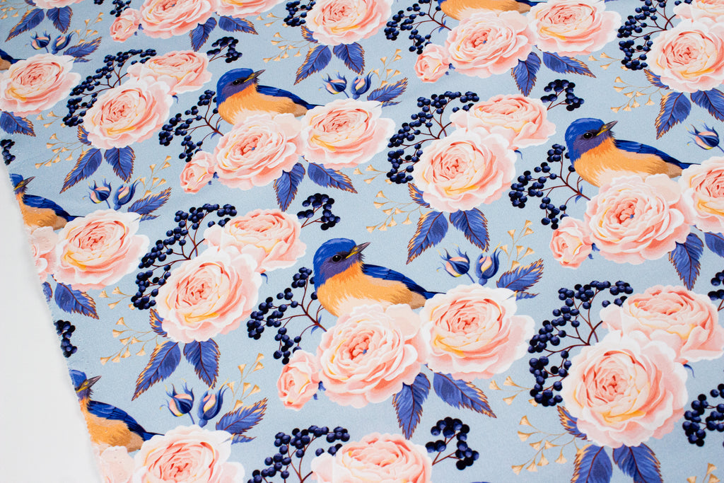 Roses with a bird on blue