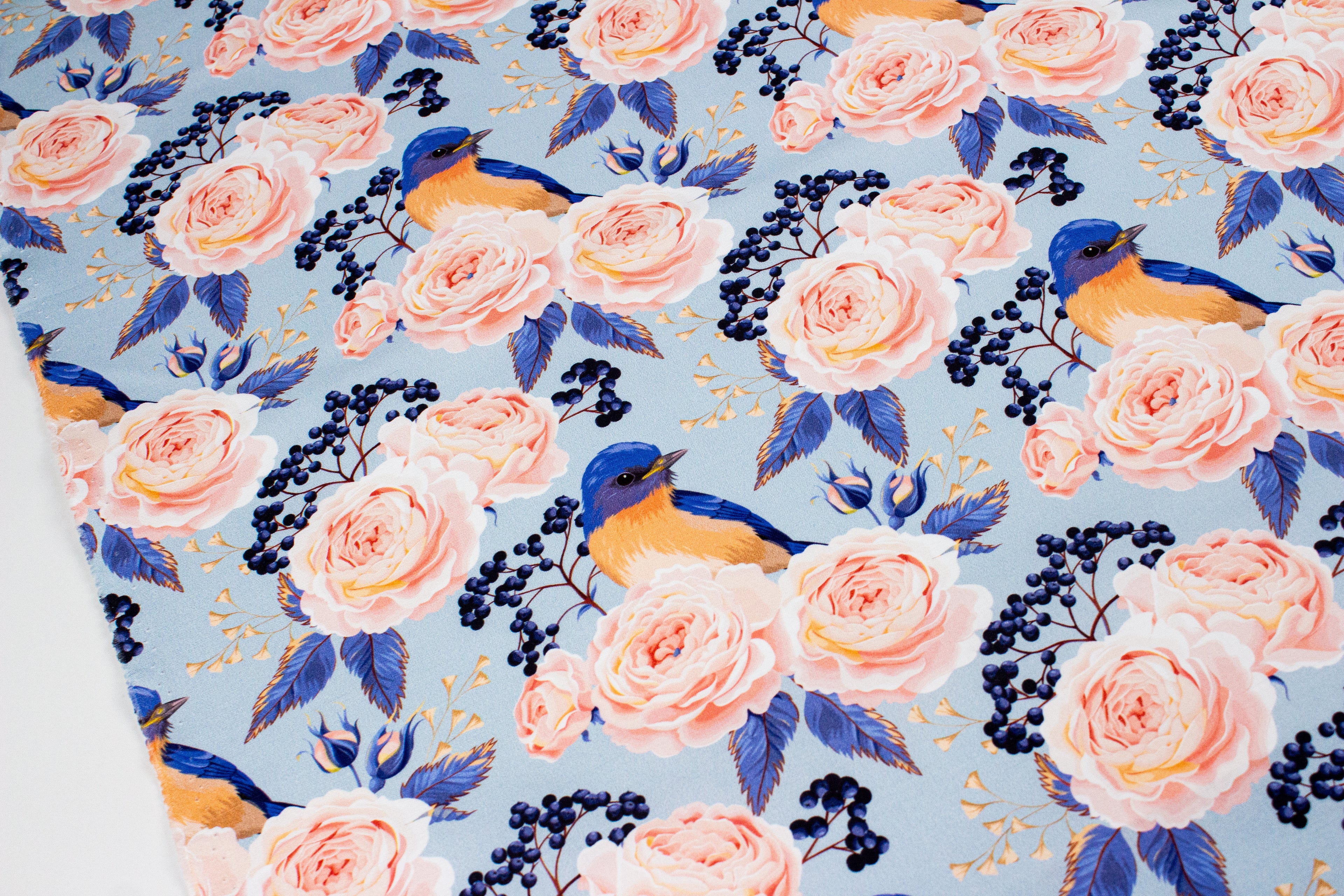 Roses with a bird on blue