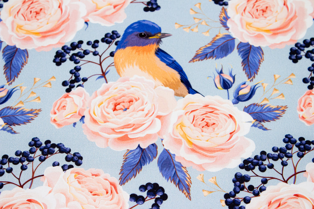 Roses with a bird on blue