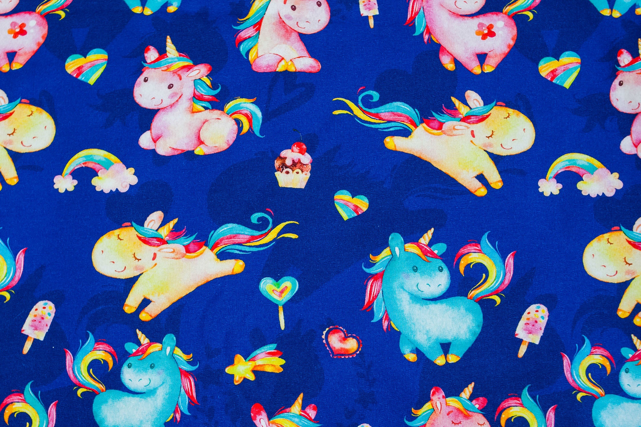Twin unicorns on blue
