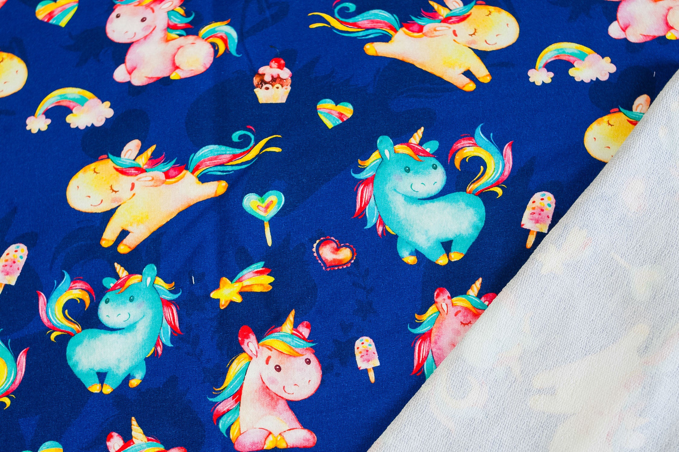 Twin unicorns on blue